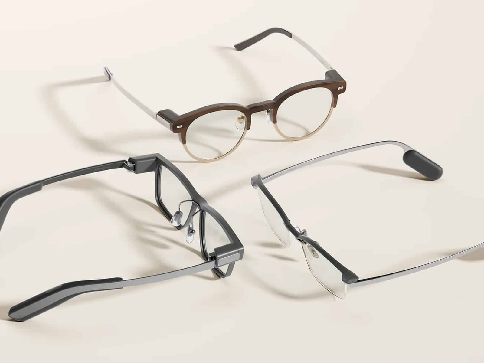Three MemoMind One frame styles laid out on a cream background, showing round, square and rimless designs