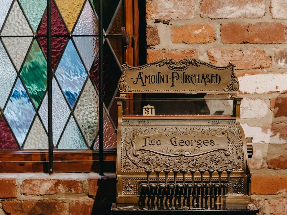 Vintage cash register inside The Two Georges Barbershop in Fremantle