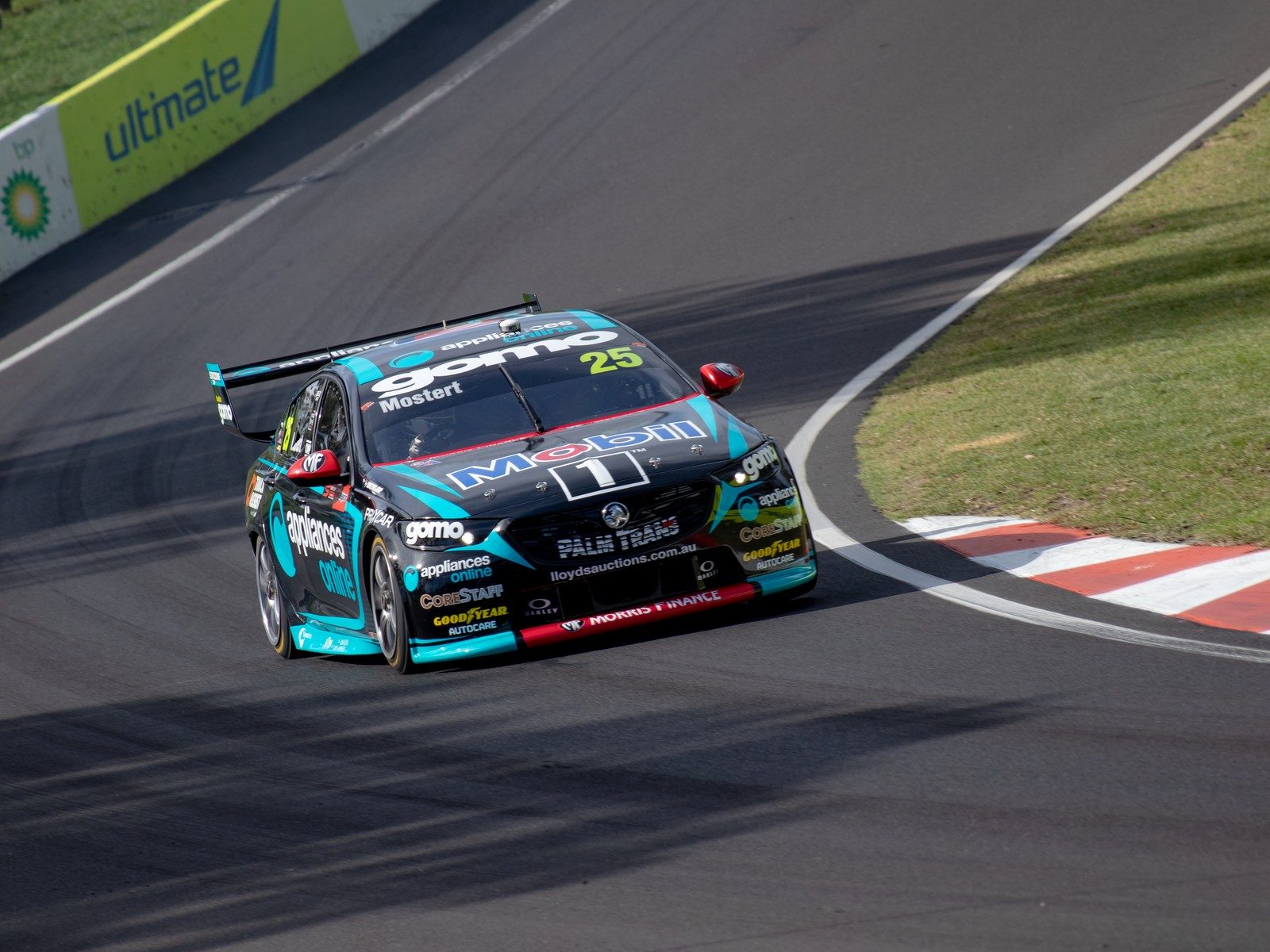 A V8 Supercar cornering at speed on the Mount Panorama circuit at Bathurst, Australia