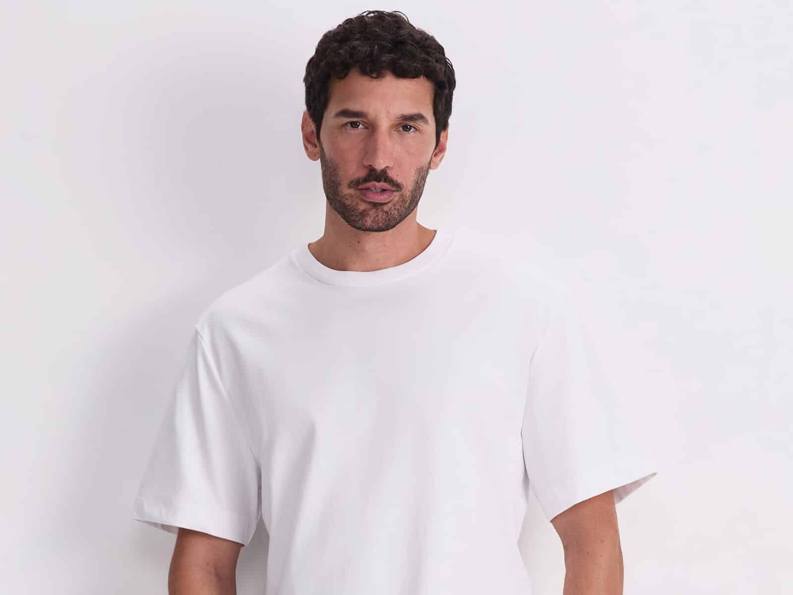 A man wearing the Sportscraft Heavyweight Cotton Tee in White with navy pants