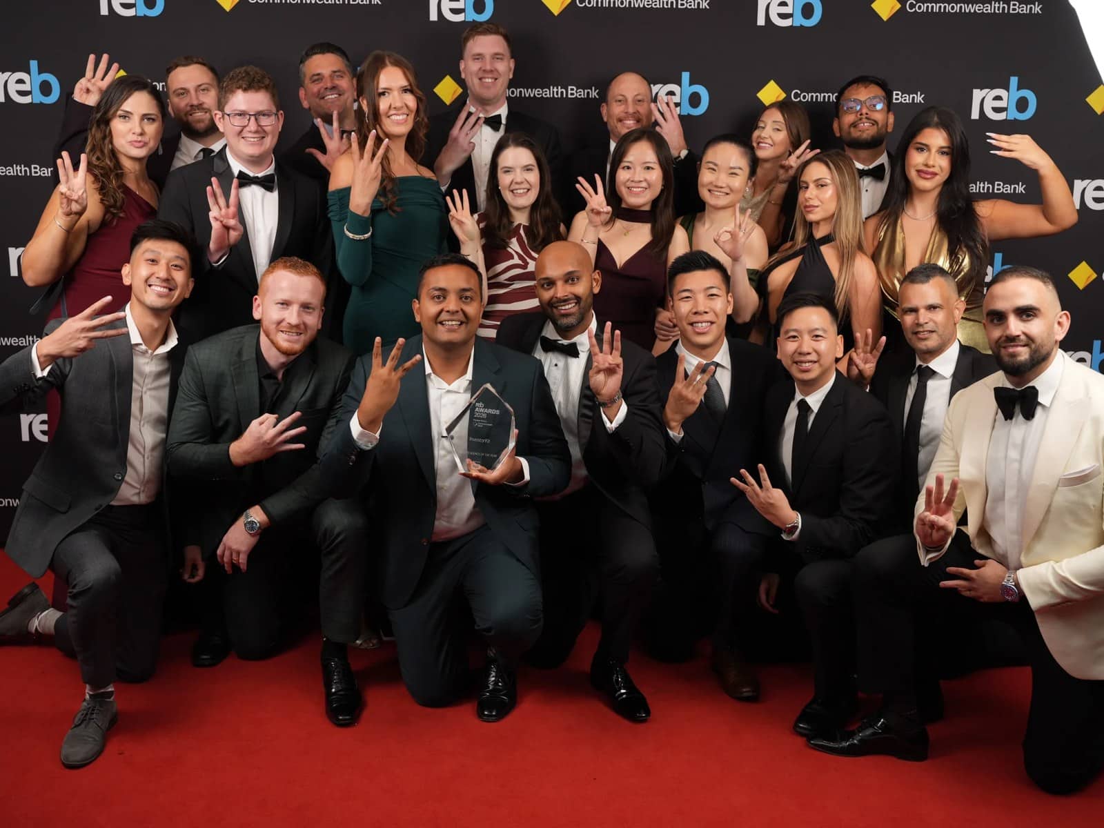 The InvestorKit team in formal wear posing together on the red carpet at the 2026 REB Awards