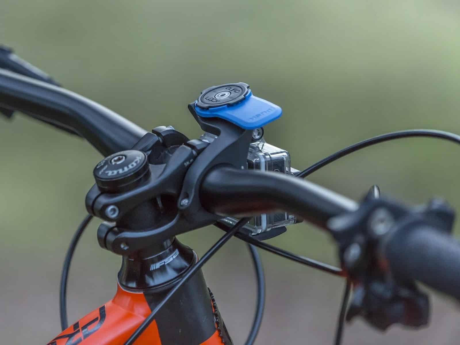 A close-up of a Quad Lock Out Front Mount fitted ahead of mountain bike handlebars