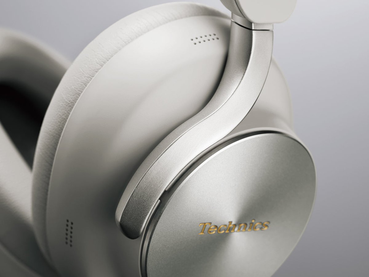 Close-up of the Technics EAH-A1000 in Platinum Greige showing the metal Flow Arm and circular machined earcup