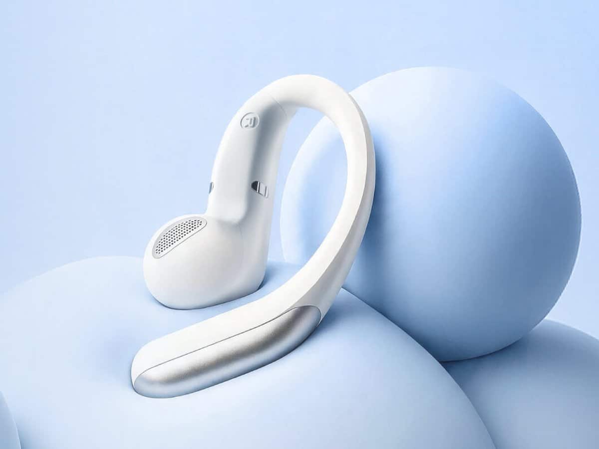 A single silver Timekettle LiveTalk earbud showing its open-ear hook design against pale blue spheres