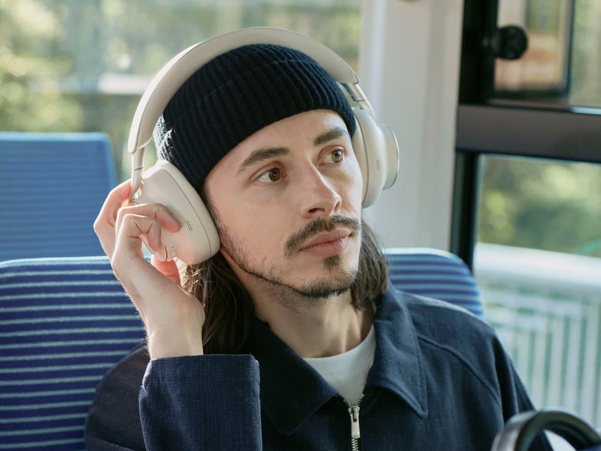 Man wearing Technics EAH-A1000 headphones in Platinum Greige on a train