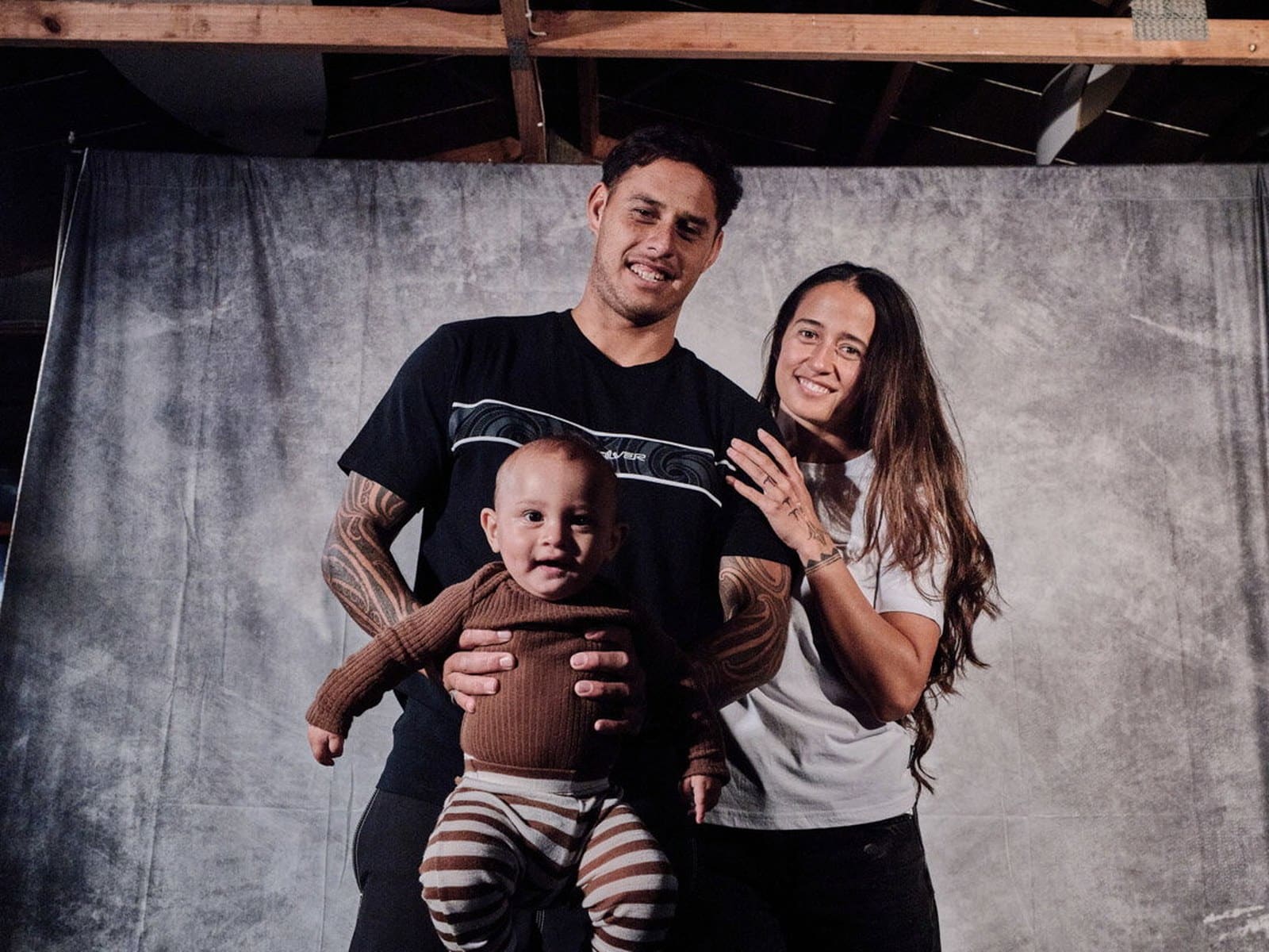 Kehu Butler with his wife and young son wearing Tai Kehu tees